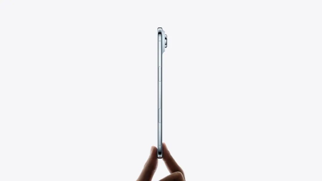 Hand holds iPhone Air from the bottom with fingertips, very thin side profile, titanium side exterior, Side button, Camera Control button, raised camera lens, sky blue colour